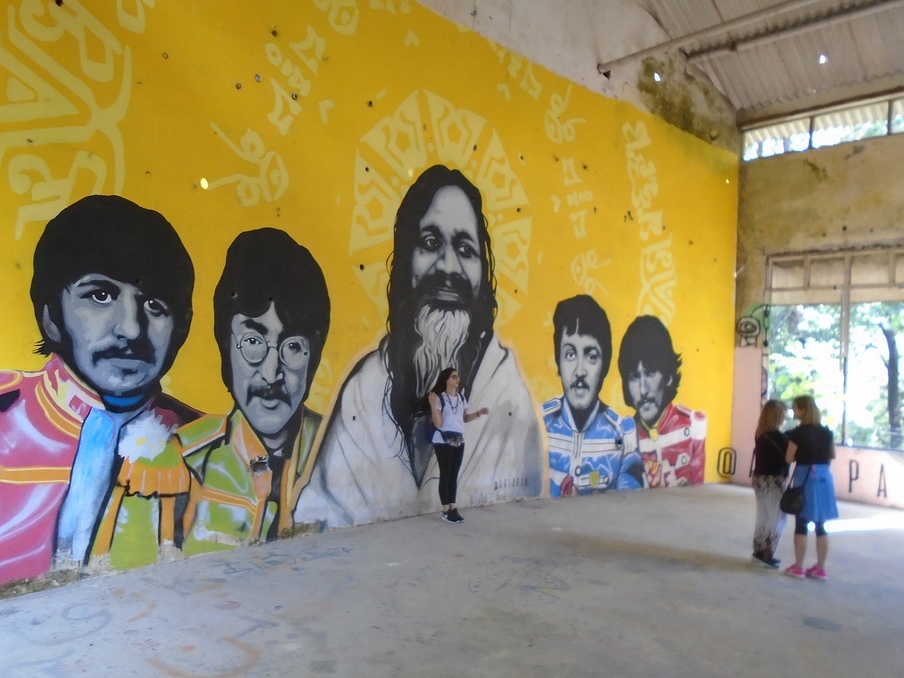 A modern mural at the ashram, depicting The Beatles and Maharishi Mahesh Yogi.