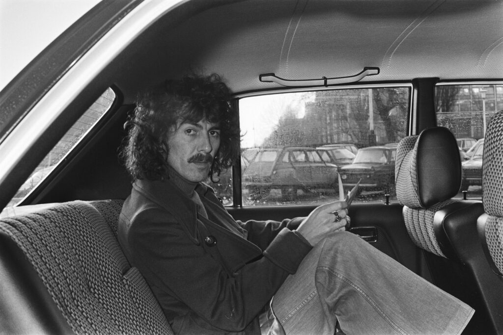 George Harrison in back of car