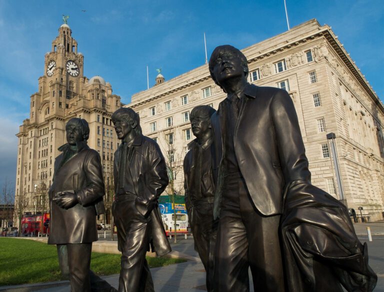 The Beatles Statues at the waterfront in front of the Liver Buildings in Liverpool