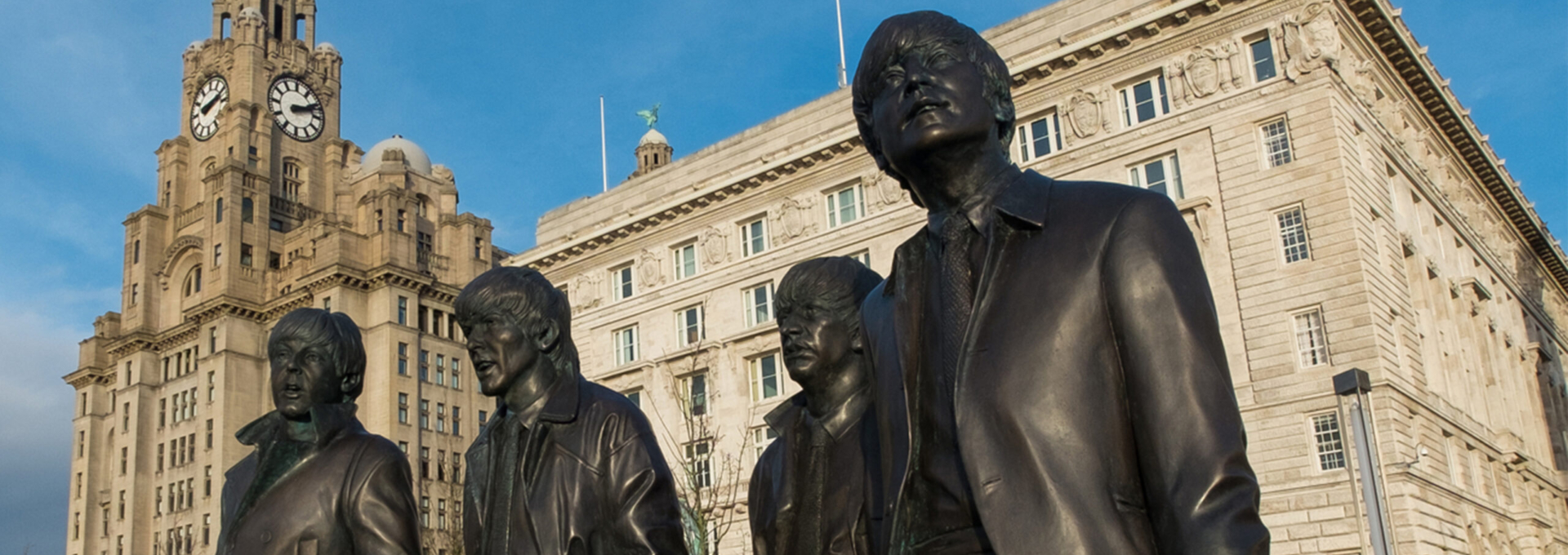 The Beatles Statues at the waterfront in front of the Liver Buildings in Liverpool