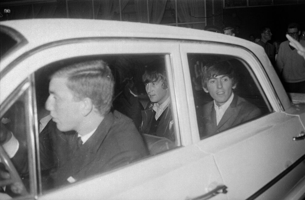 john and george in the back of a car