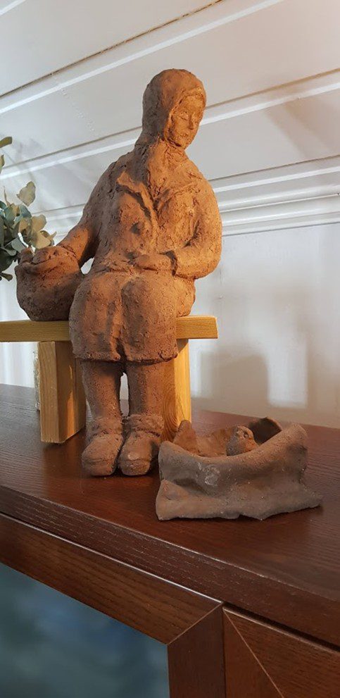 A miniature ceramic replica of the Eleanor Rigby Statue.