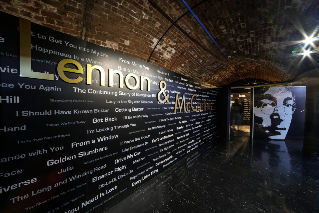 A decorated wall at The Beatles Story, dedicated to Lennon and McCartney, naming the many songs they wrote together.